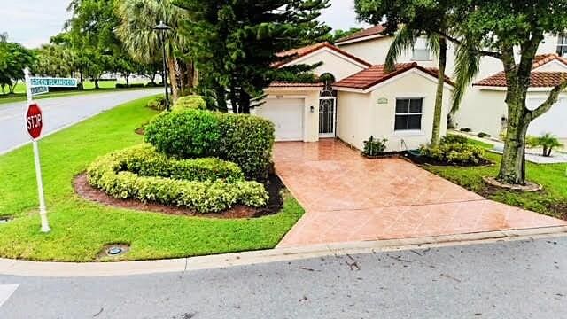 view of front of property with a garage and a front lawn