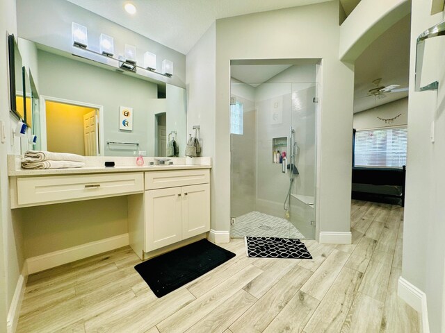 bathroom featuring an enclosed shower, wood-type flooring, and vanity