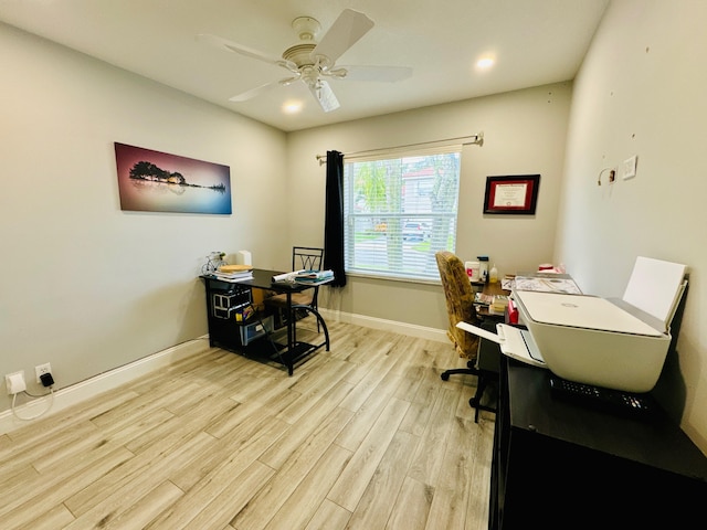 home office featuring light wood-type flooring and ceiling fan