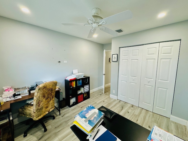 office area with light wood-type flooring and ceiling fan