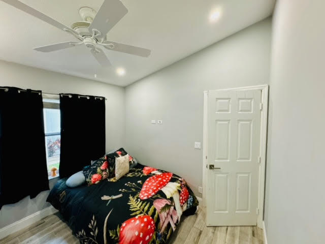 bedroom featuring light hardwood / wood-style floors and ceiling fan