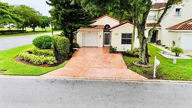 mediterranean / spanish home featuring a front lawn