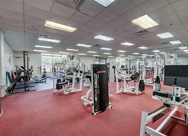 exercise room featuring a drop ceiling