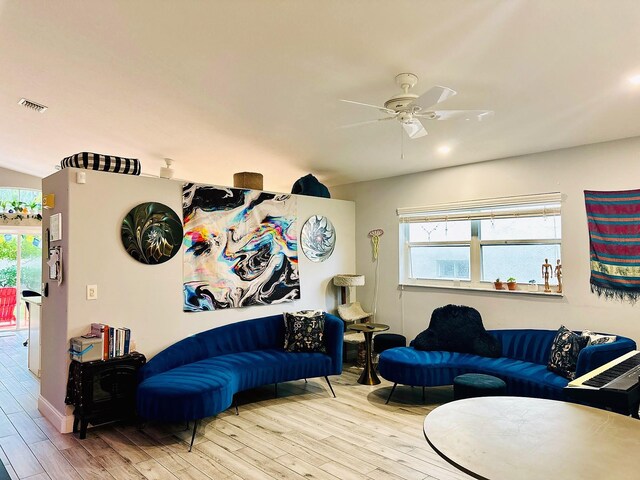 living room with ceiling fan and light hardwood / wood-style flooring