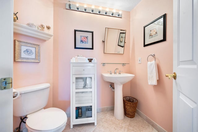 bathroom with tile patterned flooring and toilet