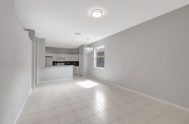 unfurnished living room with light tile patterned floors