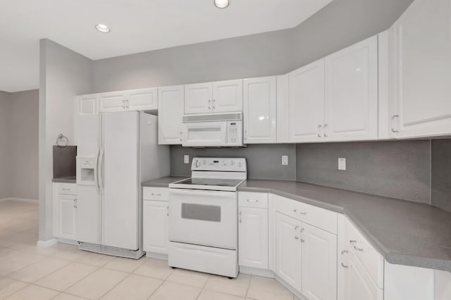 kitchen featuring light tile patterned flooring, white appliances, backsplash, and white cabinets