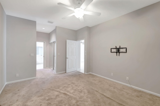 carpeted spare room featuring ceiling fan