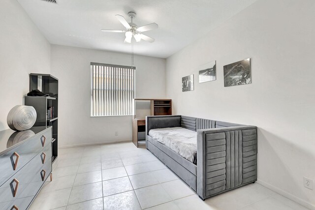 tiled spare room featuring ceiling fan