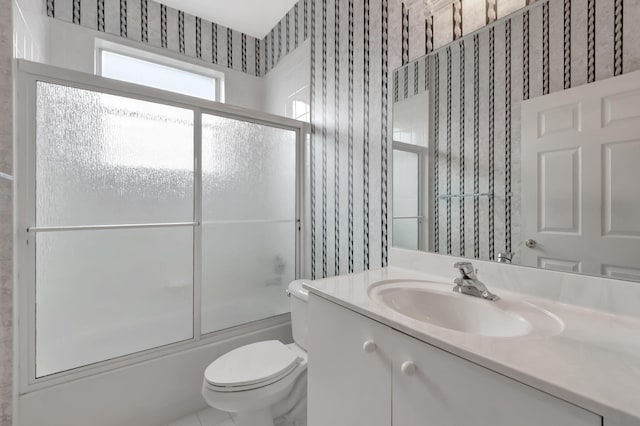 full bathroom with shower / bath combination with glass door, vanity, and toilet