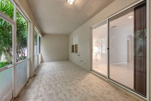 unfurnished sunroom with a wealth of natural light