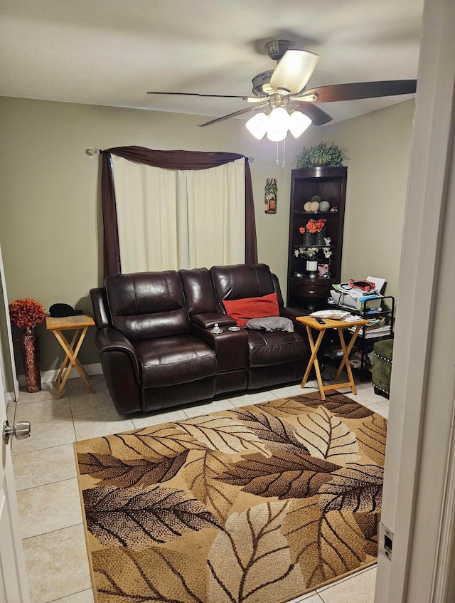 living room with ceiling fan and tile patterned floors