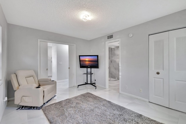 living room featuring a textured ceiling