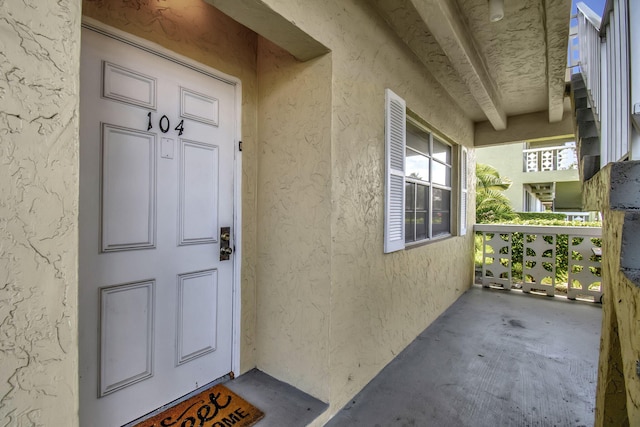 view of exterior entry featuring a porch