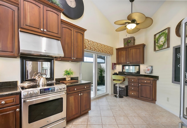 kitchen with electric range, ceiling fan, light tile patterned floors, and high vaulted ceiling