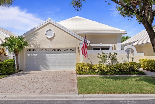 view of front of property featuring a garage and a front lawn