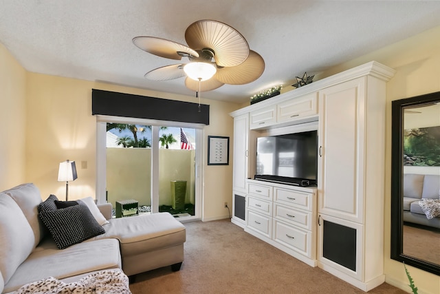 living room with light carpet, ceiling fan, and a textured ceiling