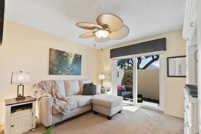 carpeted living room featuring a textured ceiling and ceiling fan