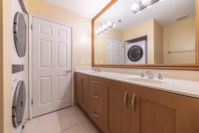 bathroom with vanity, tile patterned floors, and stacked washing maching and dryer