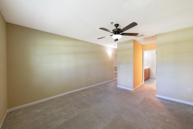 carpeted empty room with ceiling fan and a textured ceiling