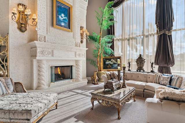 living room with carpet and a large fireplace