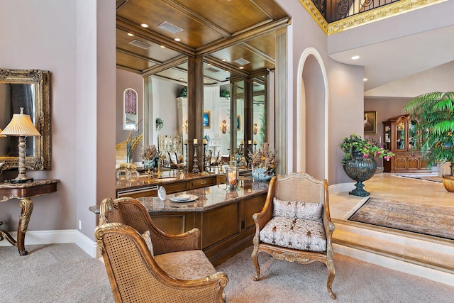 living area with carpet, indoor bar, and ornamental molding