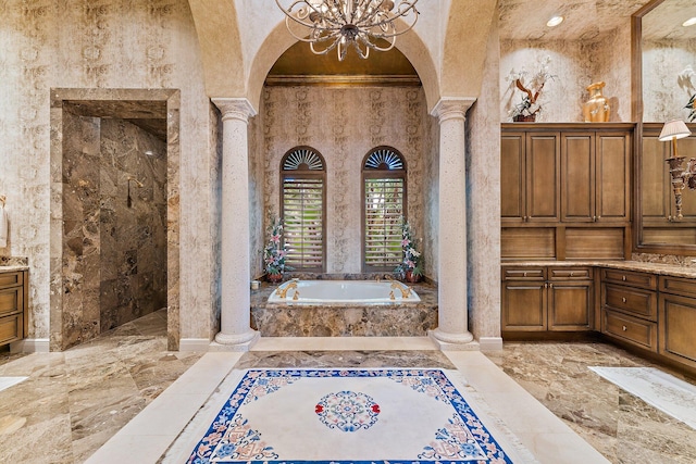 bathroom with decorative columns, separate shower and tub, and vanity