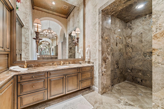 bathroom with vanity, a shower, ornamental molding, and an inviting chandelier