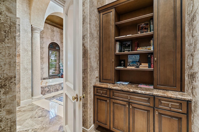 interior space featuring ornate columns and crown molding