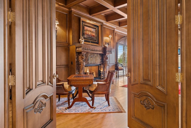 sitting room with a high end fireplace, coffered ceiling, hardwood / wood-style flooring, beamed ceiling, and wood walls