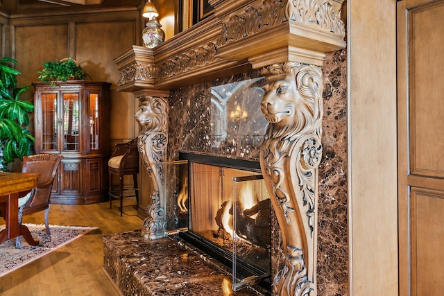 room details featuring a high end fireplace and hardwood / wood-style flooring