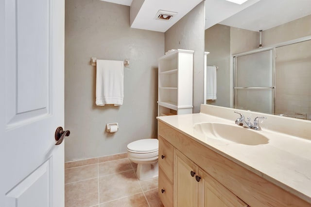 bathroom with tile patterned flooring, an enclosed shower, vanity, and toilet