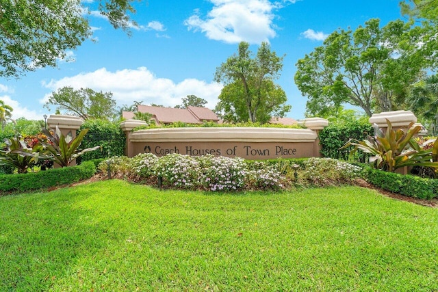 community / neighborhood sign with a lawn