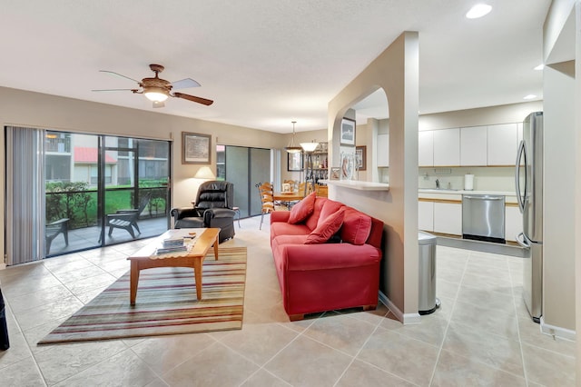 tiled living room with ceiling fan