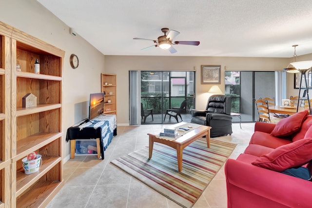 tiled living room featuring ceiling fan and a textured ceiling