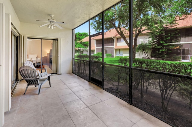 sunroom featuring ceiling fan