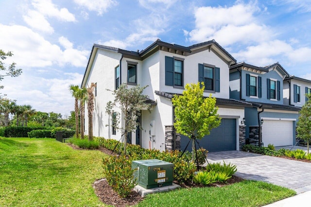 view of front of property featuring a front yard and a garage