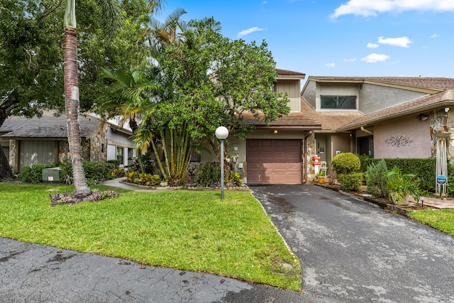 view of front of home with a garage and a front yard