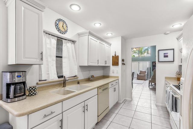 kitchen featuring white cabinetry, sink, range, and white dishwasher