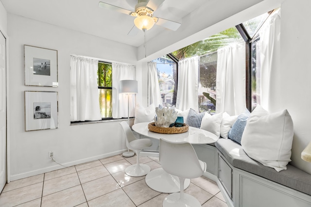 interior space featuring light tile patterned flooring, ceiling fan, and breakfast area