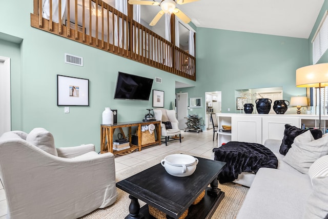 tiled living room with a towering ceiling and ceiling fan