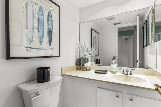 bathroom featuring vanity and toilet