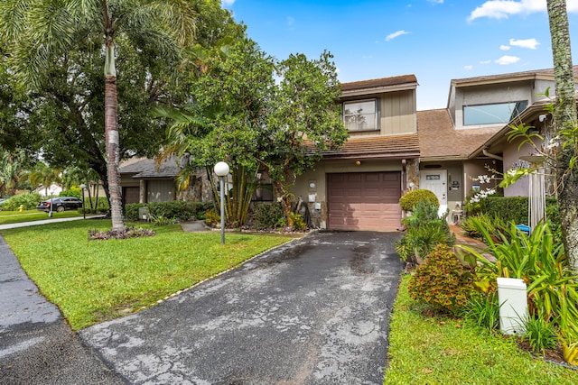 townhome / multi-family property with a garage and a front yard