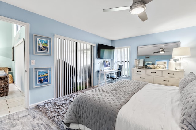 bedroom featuring light tile patterned flooring and ceiling fan