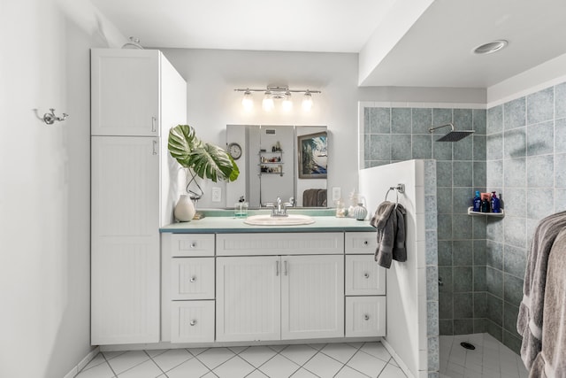 bathroom with vanity, tile patterned floors, and tiled shower