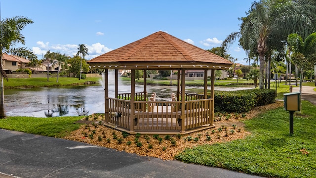 view of home's community with a lawn, a water view, and a gazebo