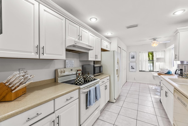 kitchen with light tile patterned flooring, white cabinetry, white appliances, and ceiling fan