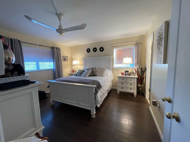 bedroom with dark hardwood / wood-style flooring and ceiling fan