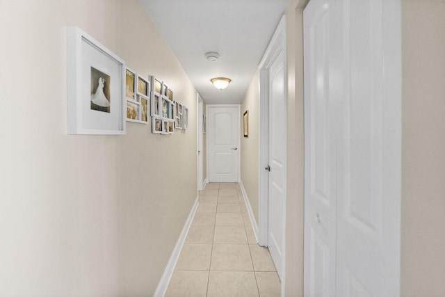 hall with light tile patterned floors