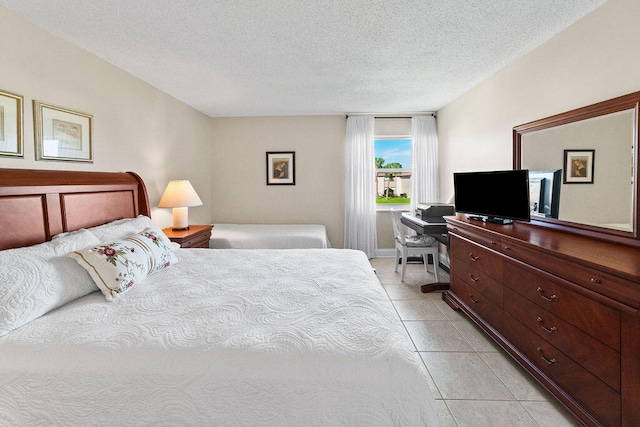 tiled bedroom with a textured ceiling